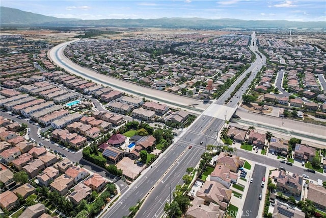 7020 Turin Pl, Eastvale, CA 92880 - aerial overview of property's location featuring a mountain backdrop and nearby suburban area