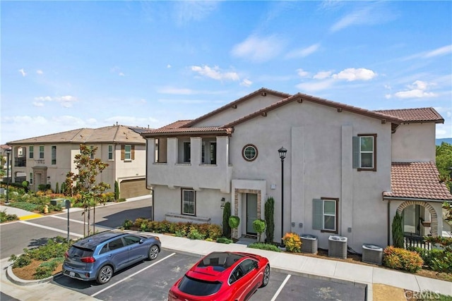 7020 Turin Pl, Eastvale, CA 92880 - view of front of home with a tile roof, uncovered parking, and stucco siding