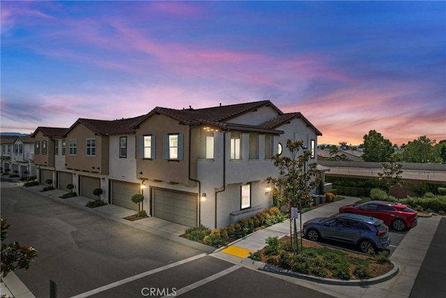 7020 Turin Pl, Eastvale, CA 92880 - view of property featuring a garage, stucco siding, driveway, and a residential view