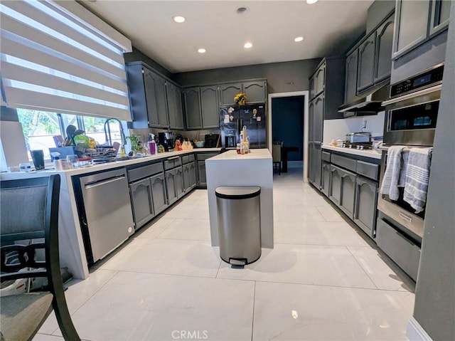 580 Hillsborough Way, Corona, CA 92879 - kitchen featuring appliances with stainless steel finishes, light countertops, recessed lighting, under cabinet range hood, and a kitchen island