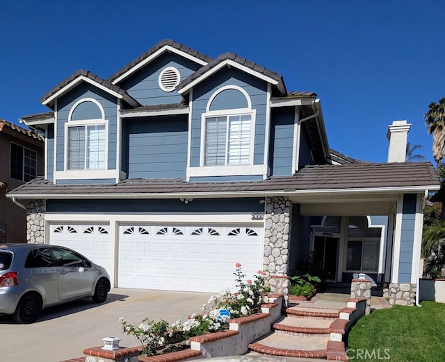 580 Hillsborough Way, Corona, CA 92879 - view of front of property featuring an attached garage, concrete driveway, a chimney, and stone siding