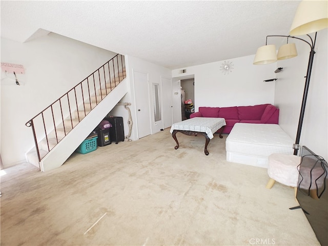 12836 12th St Unit 27, Chino, CA 91710 - carpeted living room with stairs and a textured ceiling