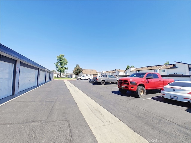 12836 12th St Unit 27, Chino, CA 91710 - view of asphalt road featuring a residential view and community garages