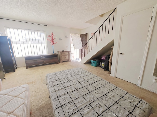 12836 12th St Unit 27, Chino, CA 91710 - foyer with carpet, a textured ceiling, and stairs