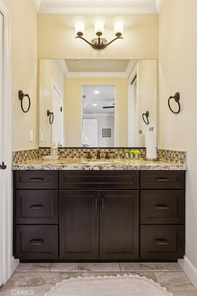 3032 Cortuna Dr, San Luis Obispo, CA 93401 - bathroom with vanity, tasteful backsplash, marble look tile flooring, and crown molding