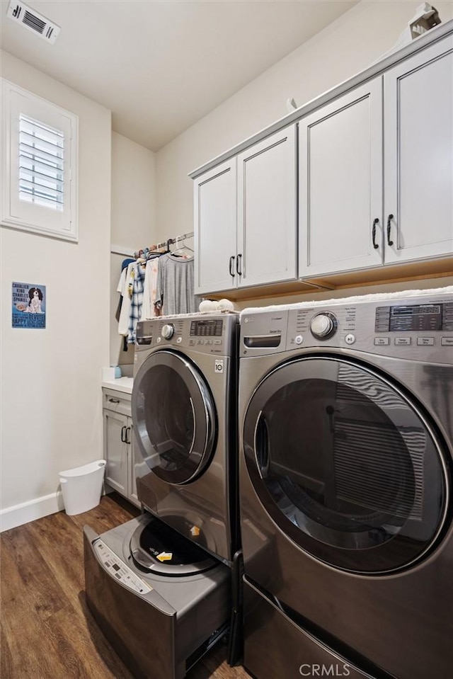 3032 Cortuna Dr, San Luis Obispo, CA 93401 - laundry room with cabinet space, washing machine and dryer, and dark wood-type flooring