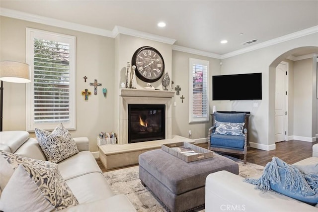 3032 Cortuna Dr, San Luis Obispo, CA 93401 - living area with arched walkways, wood finished floors, recessed lighting, a glass covered fireplace, and ornamental molding