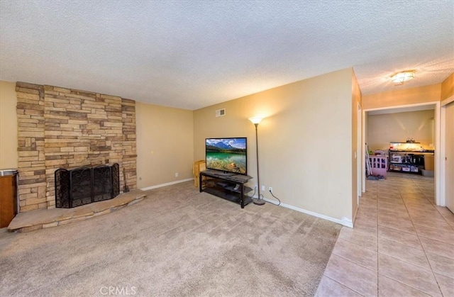 5709 Holly Ridge Dr, Camarillo, CA 93012 - living room featuring a textured ceiling, a stone fireplace, light colored carpet, and light tile patterned flooring