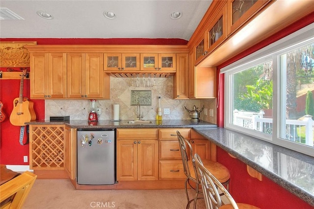 24 Edgebrook Dr, Phillips Ranch, CA 91766 - kitchen featuring refrigerator, backsplash, brown cabinetry, dark stone countertops, and recessed lighting