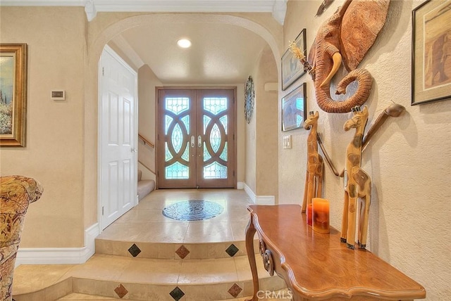 24 Edgebrook Dr, Phillips Ranch, CA 91766 - tiled foyer featuring arched walkways, a textured wall, and french doors