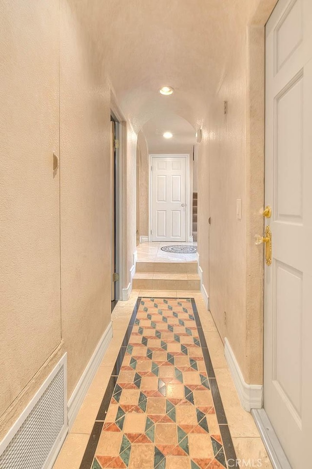 24 Edgebrook Dr, Phillips Ranch, CA 91766 - hallway featuring inlaid floor details, recessed lighting, arched walkways, and stairway