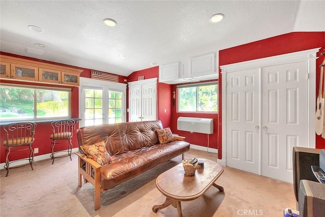 24 Edgebrook Dr, Phillips Ranch, CA 91766 - living room with light carpet, a textured ceiling, a wall mounted AC, and vaulted ceiling
