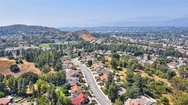 24 Edgebrook Dr, Phillips Ranch, CA 91766 - aerial overview of property's location featuring a mountain backdrop and nearby suburban area