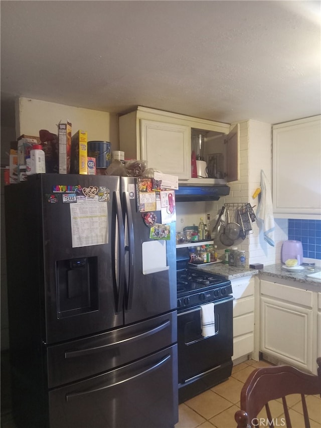 2229 Powers St, Pomona, CA 91766 - kitchen featuring stainless steel refrigerator with ice dispenser, black range with gas cooktop, white cabinets, light tile patterned floors, and under cabinet range hood