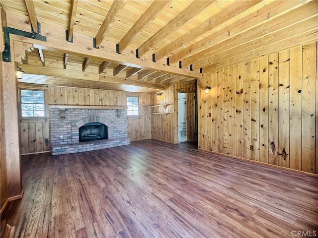 349 Golf Course Rd, Lake Arrowhead, CA 92352 - unfurnished living room featuring wood finished floors, wooden walls, plenty of natural light, a wood ceiling with exposed beams, and a brick fireplace