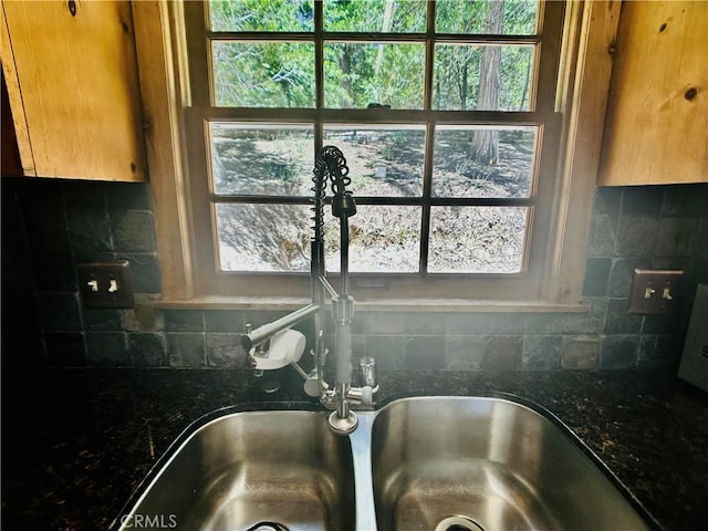 349 Golf Course Rd, Lake Arrowhead, CA 92352 - kitchen view of backsplash, dark stone counters, and brown cabinetry
