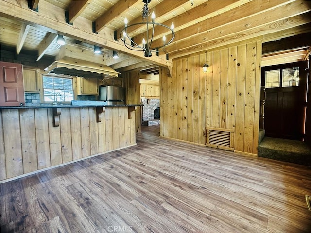 349 Golf Course Rd, Lake Arrowhead, CA 92352 - kitchen with freestanding refrigerator, a chandelier, dark countertops, wood finished floors, and wood walls