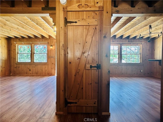 349 Golf Course Rd, Lake Arrowhead, CA 92352 - empty room with healthy amount of natural light, hardwood / wood-style floors, wood walls, and beam ceiling