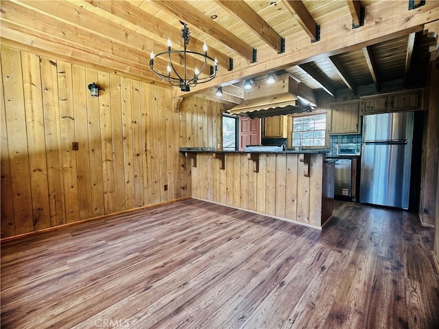 349 Golf Course Rd, Lake Arrowhead, CA 92352 - kitchen with appliances with stainless steel finishes, dark countertops, dark wood finished floors, a peninsula, and a wood ceiling with exposed beams