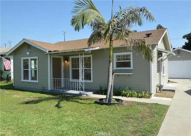 9422 Bartolo Ave, Pico Rivera, CA 90660 - view of front facade with a front lawn, a garage, covered porch, an outbuilding, and roof with shingles