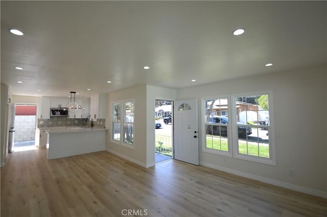 9422 Bartolo Ave, Pico Rivera, CA 90660 - unfurnished living room with light wood finished floors, healthy amount of natural light, and recessed lighting