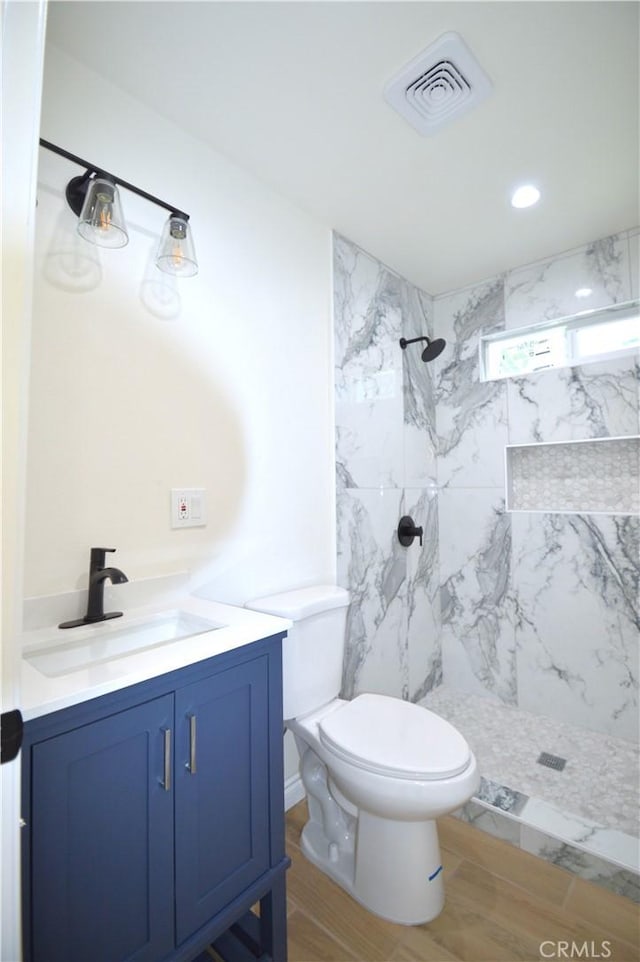 9422 Bartolo Ave, Pico Rivera, CA 90660 - bathroom featuring vanity, a marble finish shower, and wood finished floors