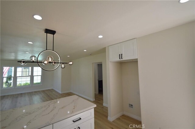 9422 Bartolo Ave, Pico Rivera, CA 90660 - kitchen featuring light wood finished floors, recessed lighting, a chandelier, white cabinetry, and light stone counters