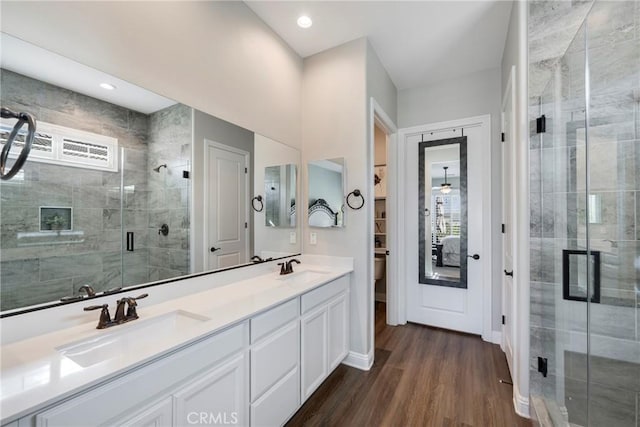 24185 Sprout Dr, Corona, CA 92883 - full bath featuring double vanity, a shower stall, and wood finished floors