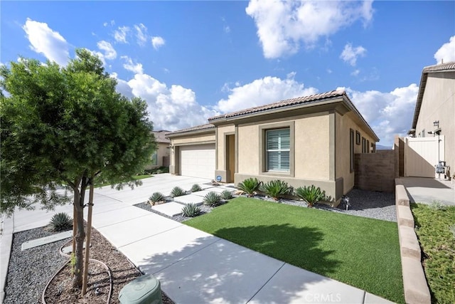 24185 Sprout Dr, Corona, CA 92883 - view of front facade featuring stucco siding, an attached garage, a tile roof, driveway, and a gate