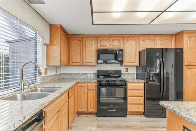 33 Edgebrook Dr, Phillips Ranch, CA 91766 - kitchen featuring black appliances, light wood-style flooring, light stone counters, and light brown cabinetry