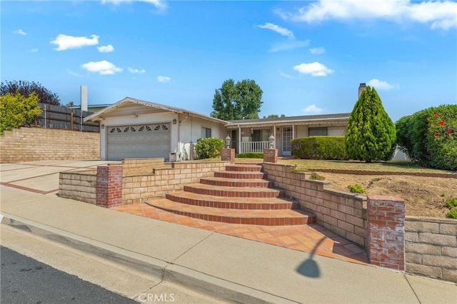 736 Highland Pl, San Dimas, CA 91773 - ranch-style house featuring a garage, concrete driveway, a porch, and stairs