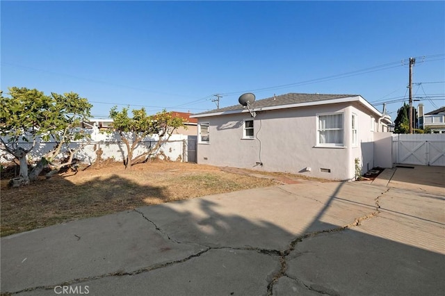 4709 W 149th St, Lawndale, CA 90260 - back of house featuring a gate, stucco siding, crawl space, and a patio area
