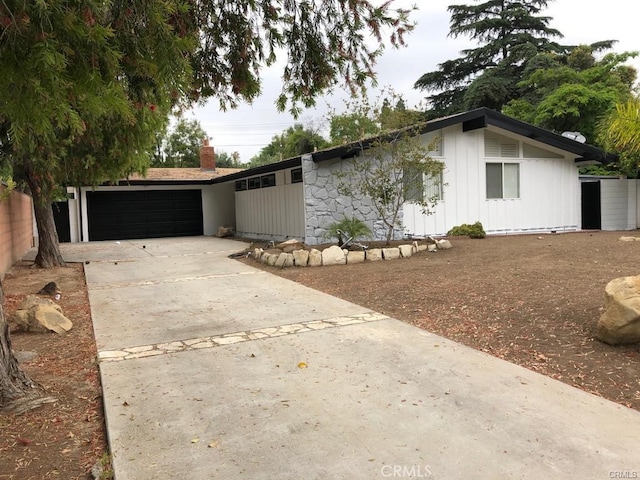 17531 Romar St, Northridge, CA 91325 - mid-century modern home with an attached garage, driveway, and board and batten siding