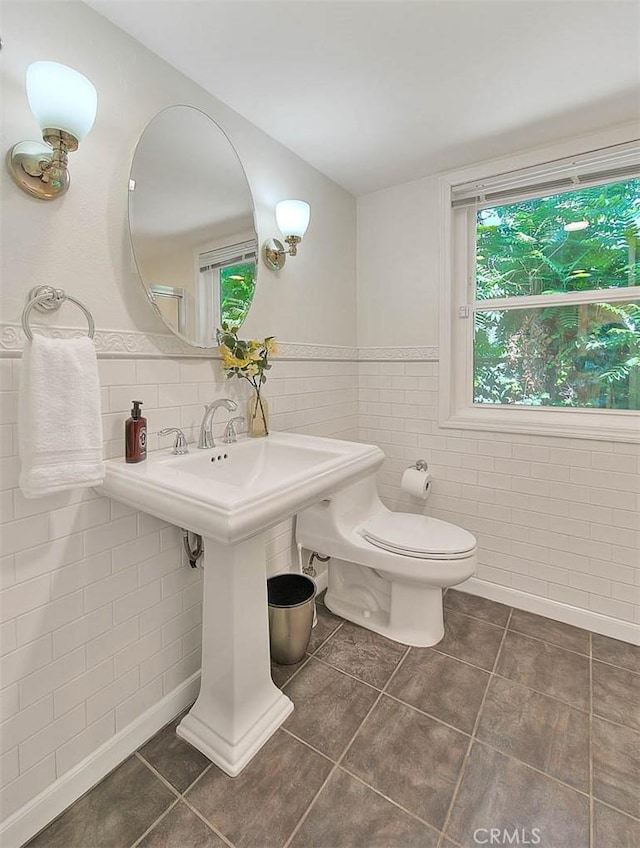 360 S Los Robles Ave Unit 10, Pasadena, CA 91101 - half bath featuring tile patterned flooring, tile walls, and wainscoting