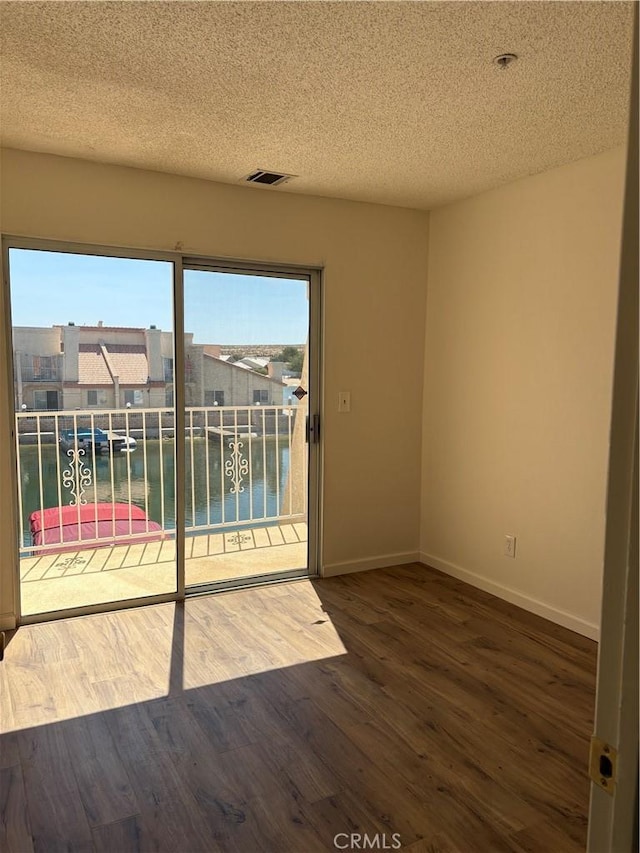 11496 Nautical Ln Unit 19, Helendale, CA 92342 - unfurnished room with a textured ceiling, wood finished floors, and a water view
