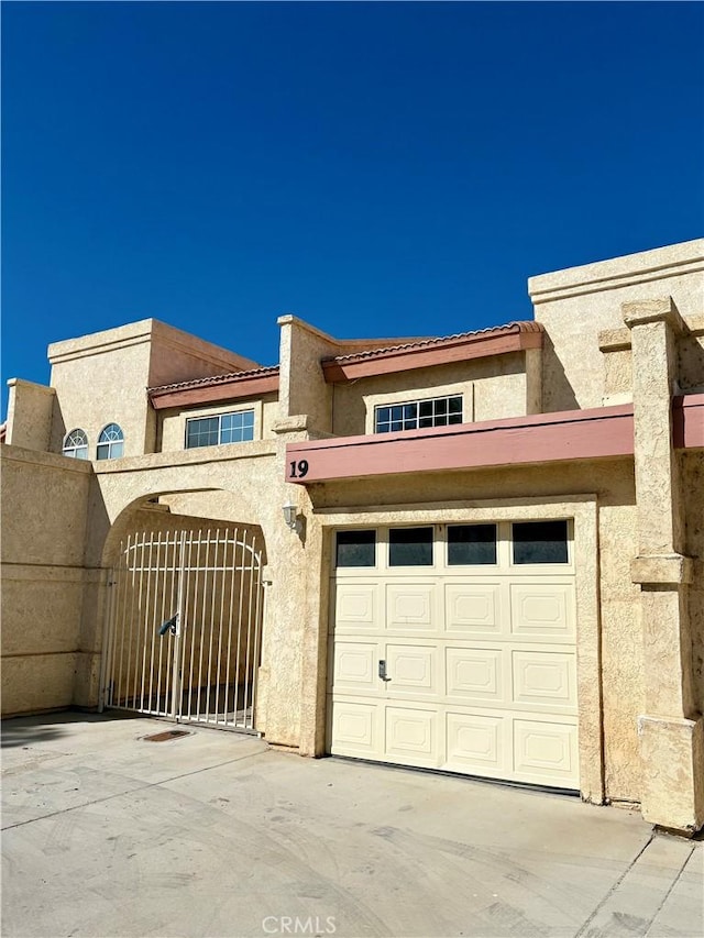 11496 Nautical Ln Unit 19, Helendale, CA 92342 - garage with concrete driveway and a gate