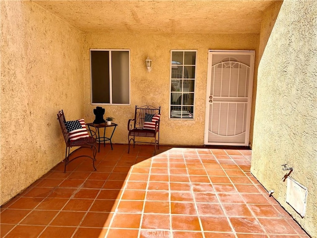 11496 Nautical Ln Unit 19, Helendale, CA 92342 - view of exterior entry with stucco siding and a patio area