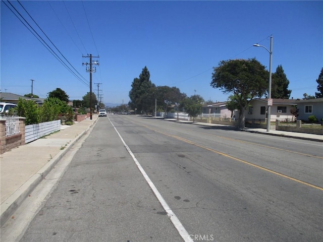12681 Trask Ave, Garden Grove, CA 92843 - view of asphalt street featuring sidewalks, curbs, and street lights