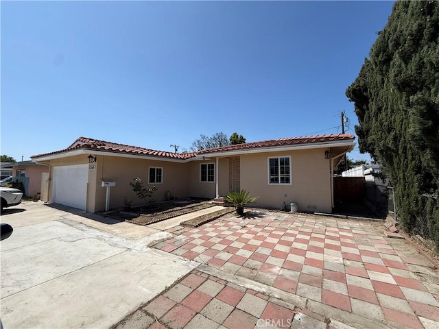 12681 Trask Ave, Garden Grove, CA 92843 - view of front of house featuring stucco siding, a garage, a tiled roof, and concrete driveway