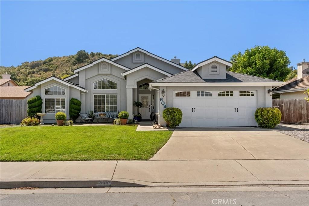 608 Grove Ct, Arroyo Grande, CA 93420 - view of front of home with a garage, stucco siding, and concrete driveway