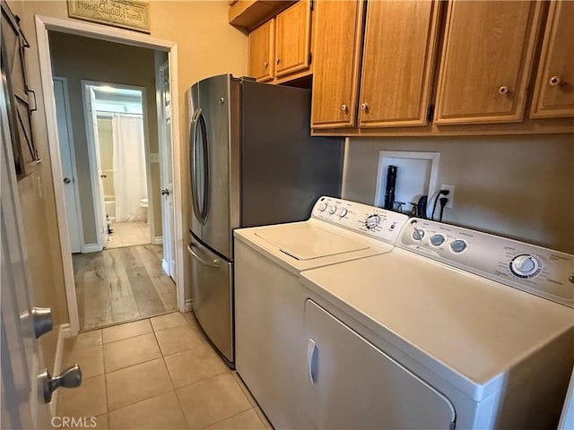 27505 Jasper Way, Castaic, CA 91384 - washroom featuring washing machine and dryer, light tile patterned floors, and cabinet space