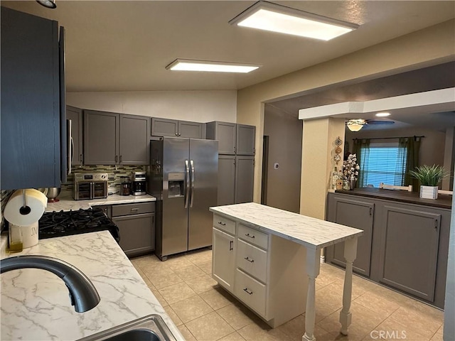 27505 Jasper Way, Castaic, CA 91384 - kitchen with stainless steel refrigerator with ice dispenser, range with gas cooktop, lofted ceiling, decorative backsplash, and light tile patterned floors