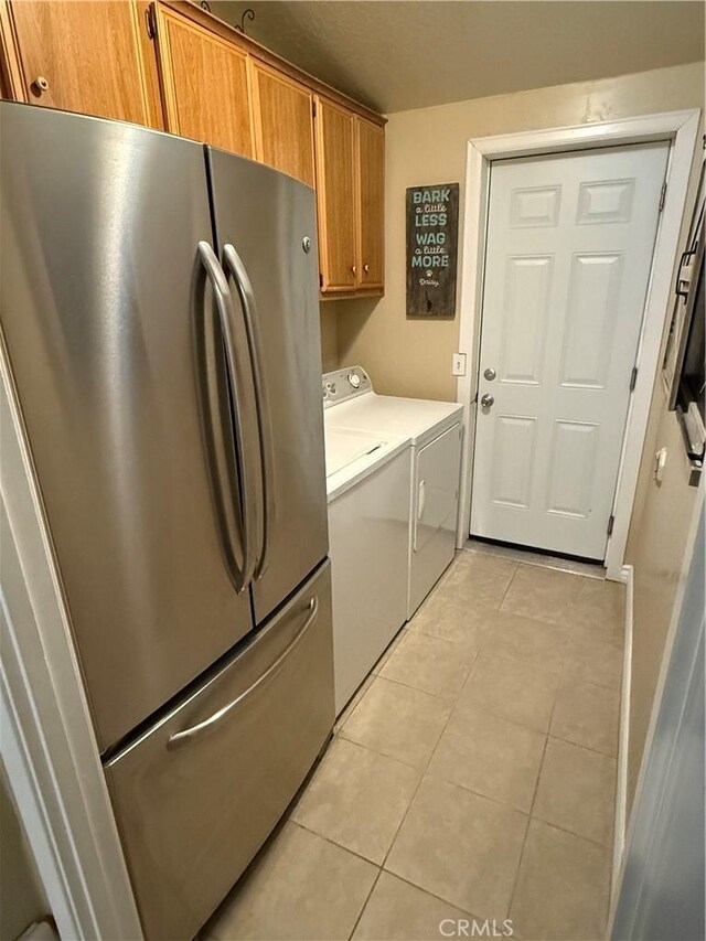 27505 Jasper Way, Castaic, CA 91384 - washroom with separate washer and dryer, light tile patterned floors, and cabinet space