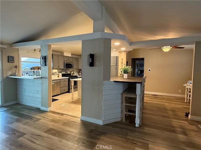 27505 Jasper Way, Castaic, CA 91384 - kitchen featuring stainless steel appliances, lofted ceiling, gray cabinets, light wood-style floors, and ceiling fan