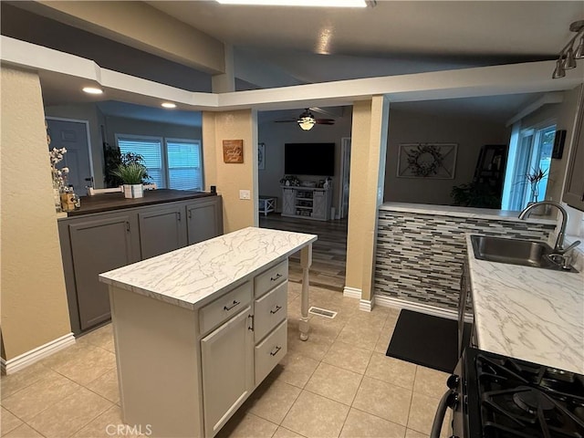 27505 Jasper Way, Castaic, CA 91384 - kitchen featuring light tile patterned floors, range with gas cooktop, ceiling fan, a center island, and lofted ceiling