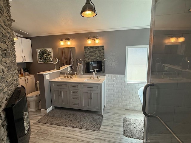 27505 Jasper Way, Castaic, CA 91384 - bathroom with double vanity, crown molding, wood finished floors, a soaking tub, and a shower with door