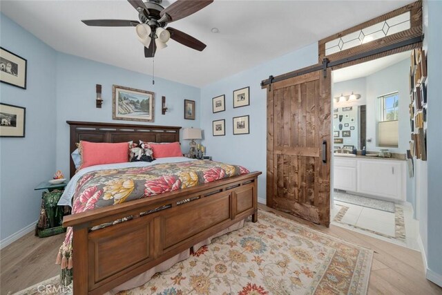 530 Bluerock Dr, San Luis Obispo, CA 93401 - bedroom featuring a barn door, light wood-style floors, ensuite bathroom, and a ceiling fan