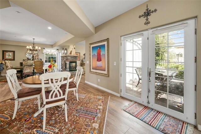 530 Bluerock Dr, San Luis Obispo, CA 93401 - dining area featuring a chandelier, light wood-type flooring, and a fireplace