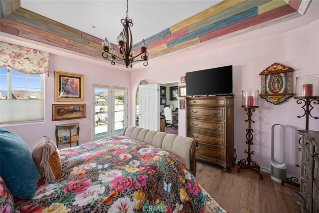 530 Bluerock Dr, San Luis Obispo, CA 93401 - bedroom featuring multiple windows, a chandelier, wood finished floors, and a raised ceiling