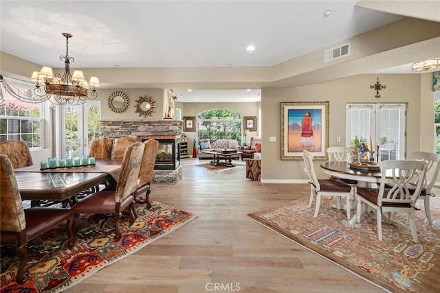 530 Bluerock Dr, San Luis Obispo, CA 93401 - dining room featuring a chandelier, wood finished floors, recessed lighting, and a stone fireplace
